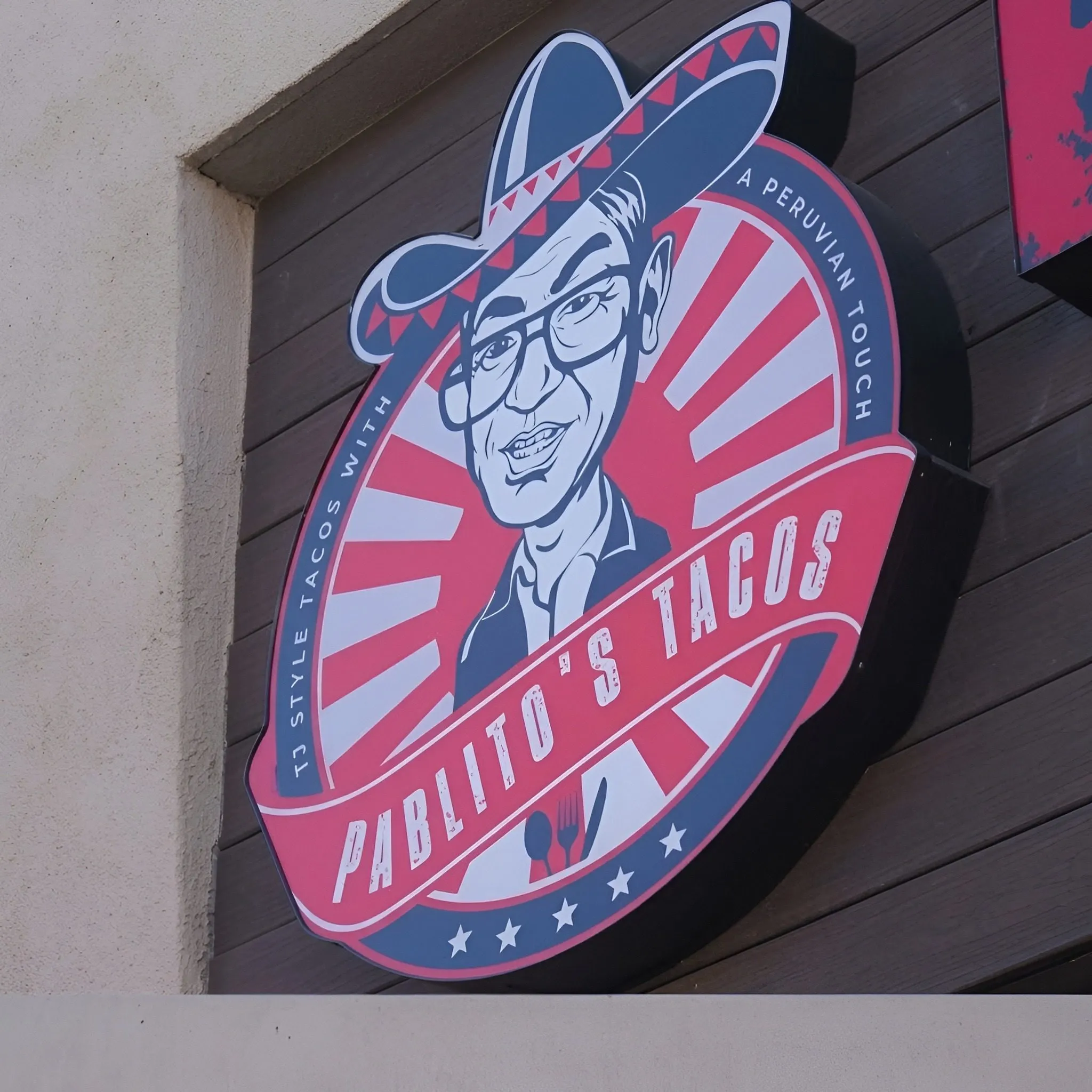 The Pablito's Tacos sunburst logo sign