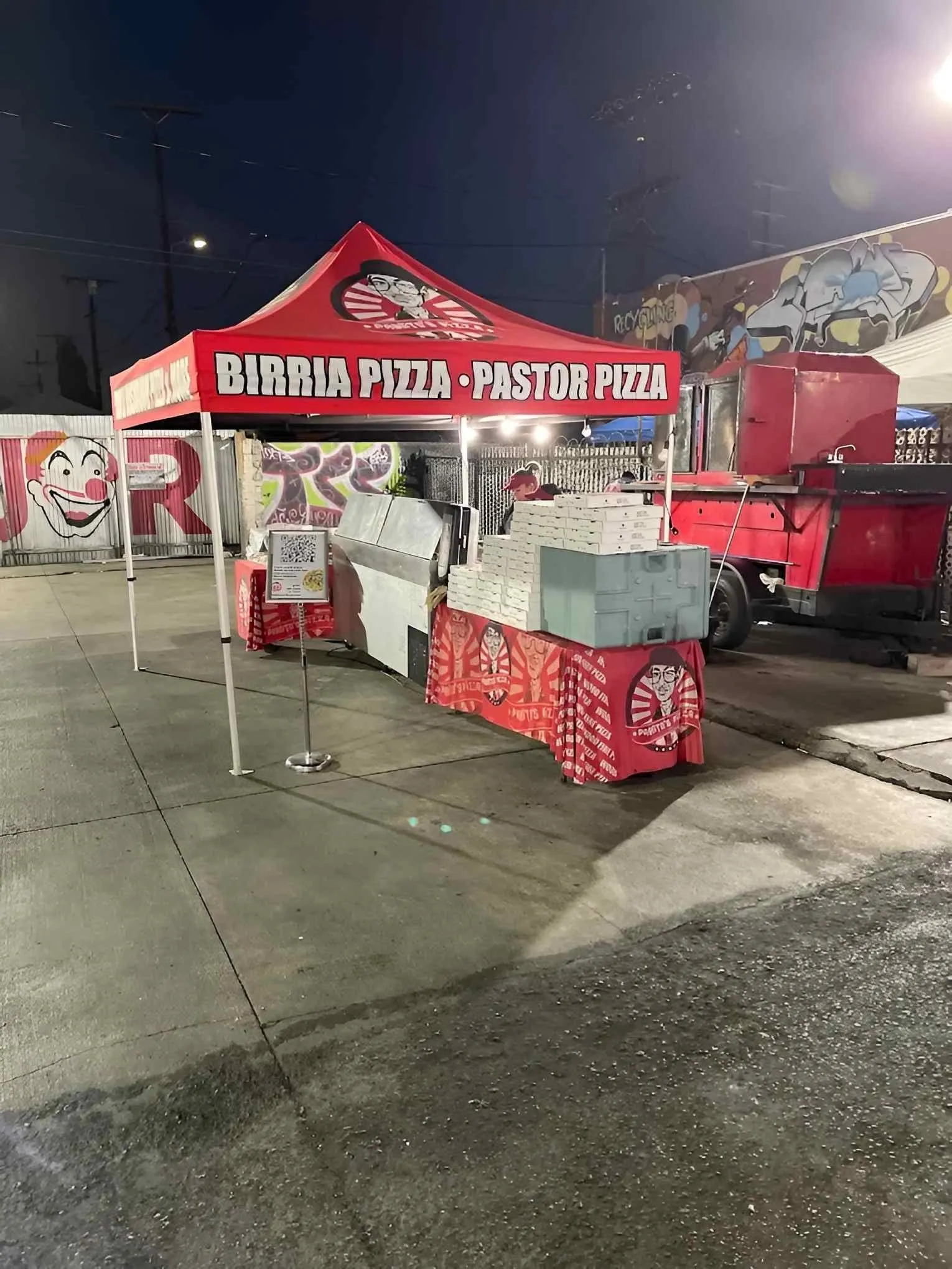 Pablito's red tents in the Circus Liquor parking lot at night