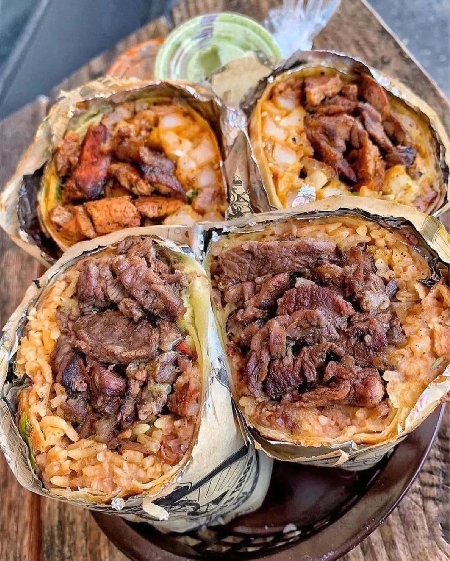 Halved burritos stuffed with lomo saltado